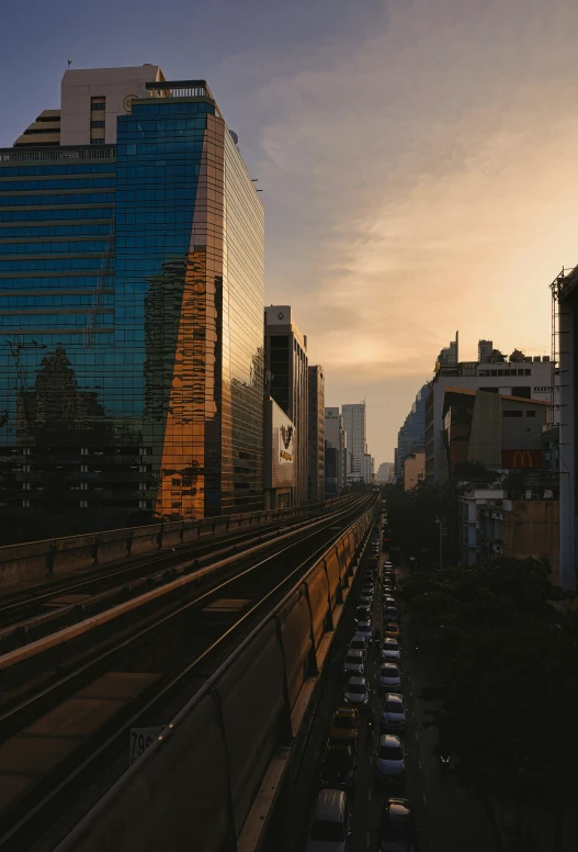 sunset over a city in the background with some very tall buildings