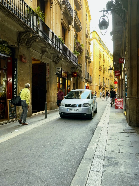 a white car parked on the street next to a building