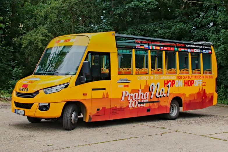 a yellow bus is parked near some trees