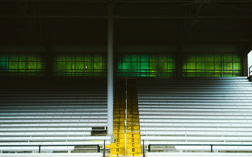 an empty stadium with rows of white seats