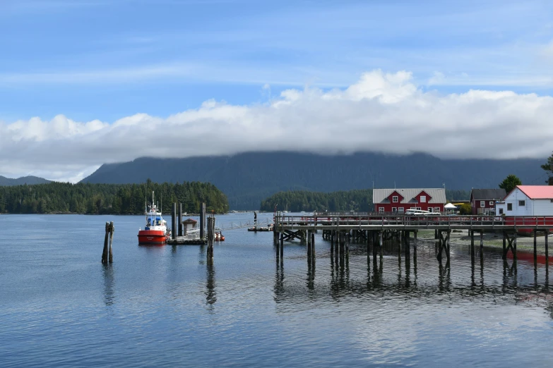 a boat is in the water next to a pier