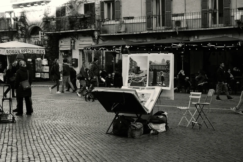 black and white image of outdoor market in an urban area