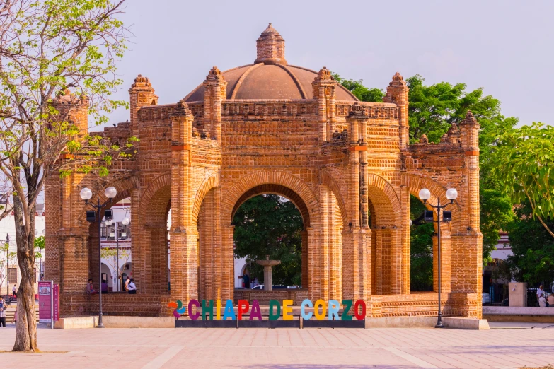 an arch in the center of a building with several colorful sculptures