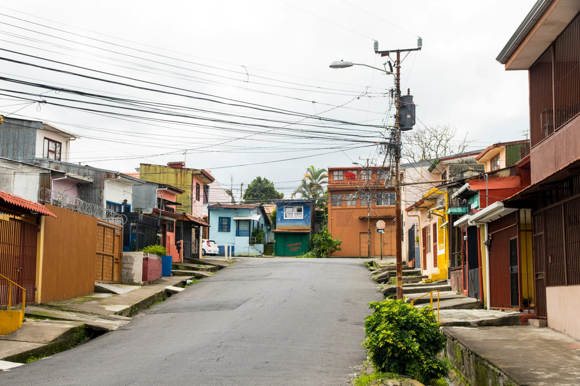 an empty street lined with colorful wooden buildings