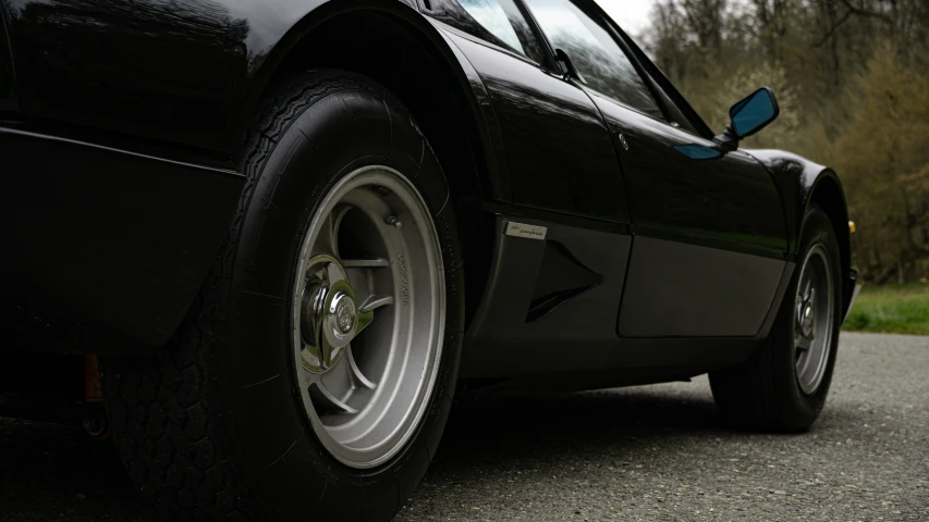 the wheel of a classic car is seen