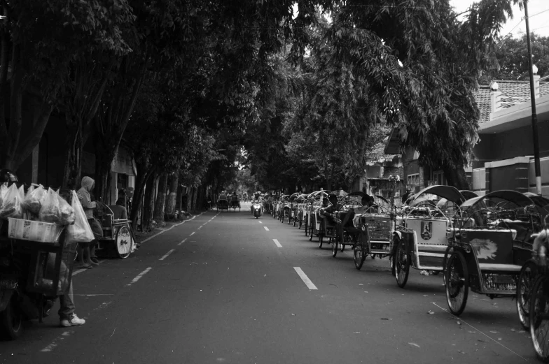 several carriages riding down the street in front of a building