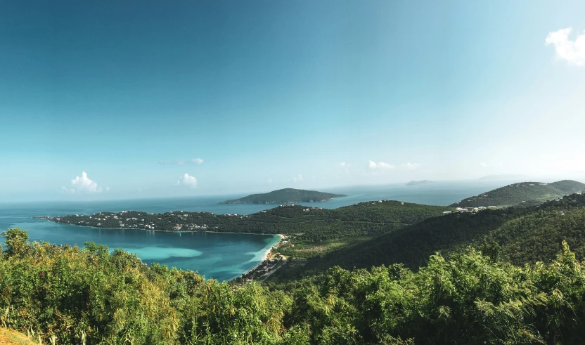 a view from the top of a hill to the ocean