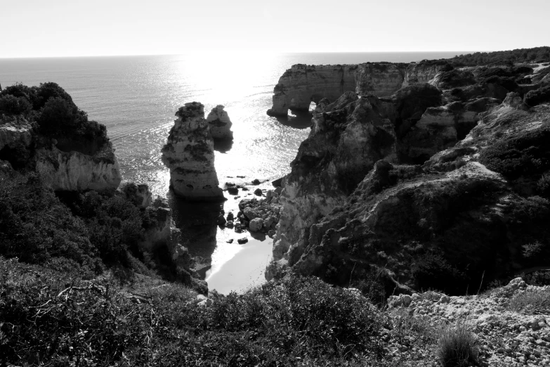 a rocky coastline with a body of water and land near by