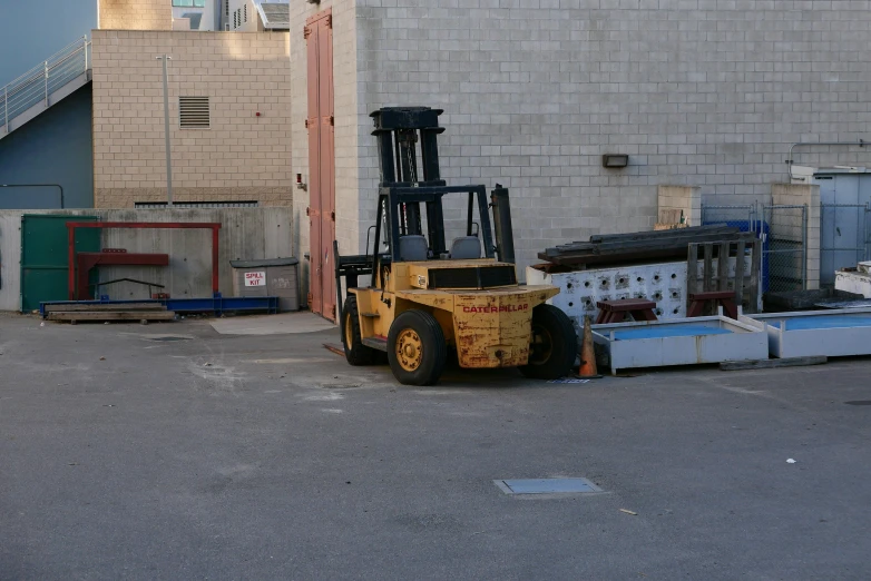 there is a forklift parked next to a building