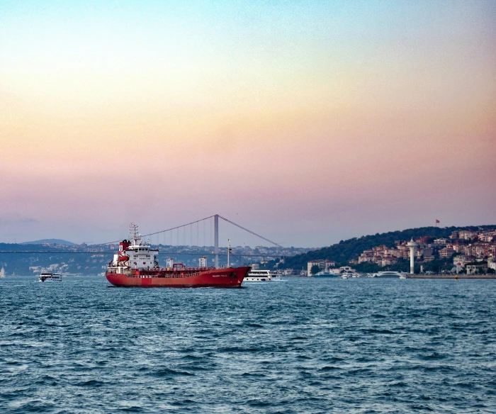 a red and white ship out on the water