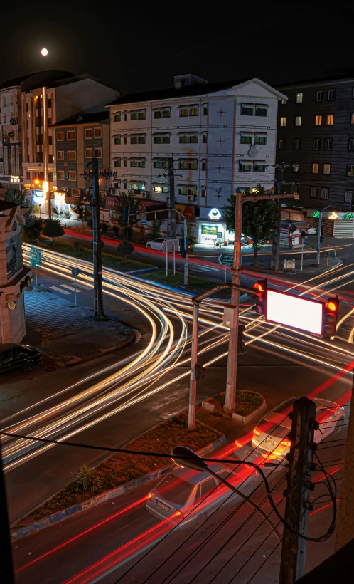 a city street with traffic at night