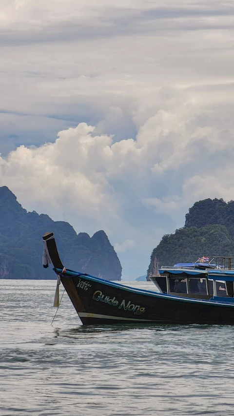 two boats on the water with hills in the background