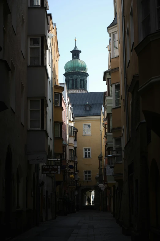 some buildings and a domed top building on the side of a street