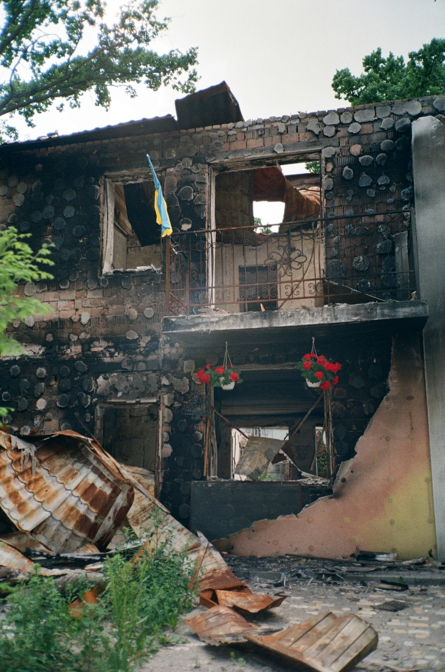 a burned out house with broken windows and a fire hydrant