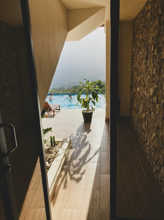 an open doorway with a potted plant outside the door