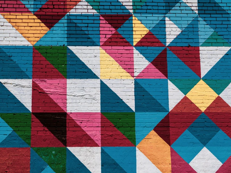 a picture of a very colorful wall in the street