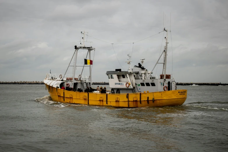 a small yellow boat sailing in the water