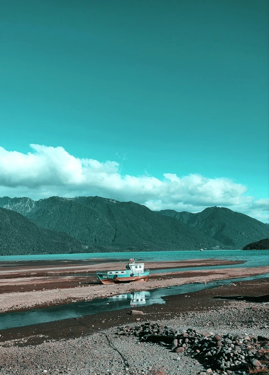 boat in the ocean and mountains on horizon