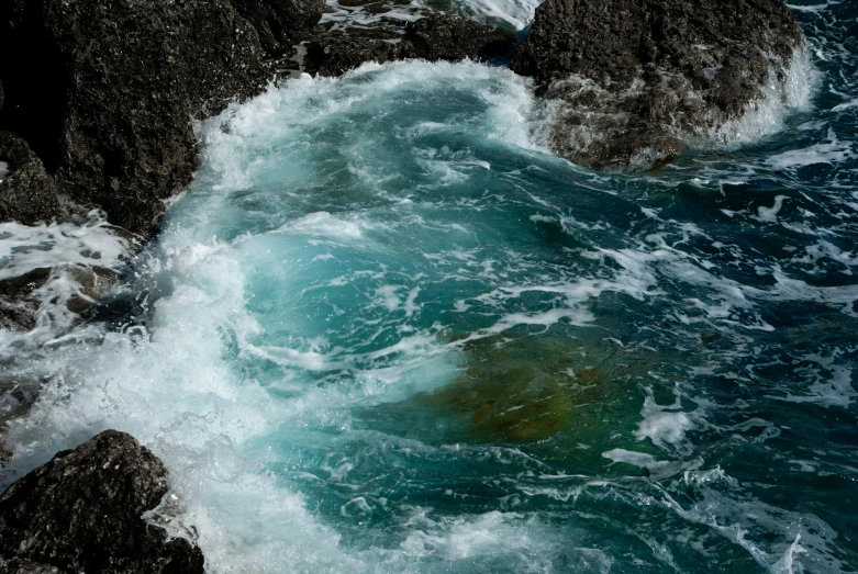 an open body of water on top of a rocky shoreline