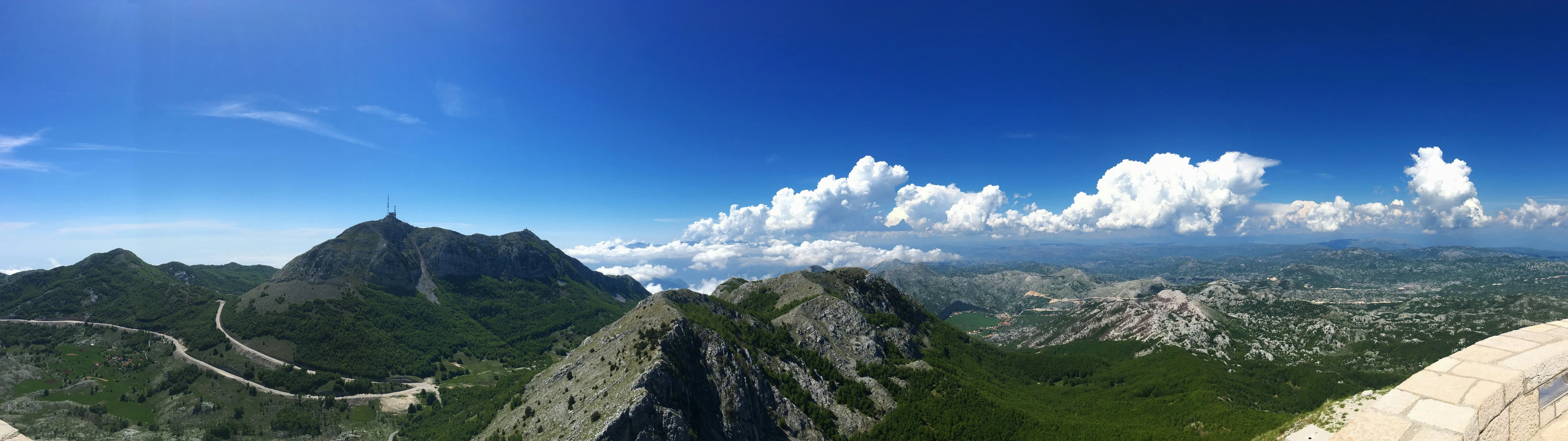 the mountains are very tall, with many clouds over them