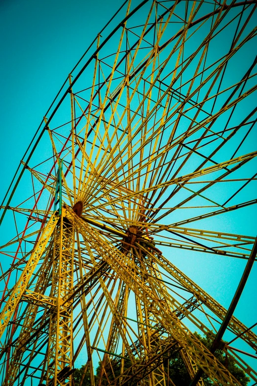 a tall ferris wheel sitting next to a lush green forest