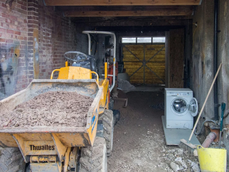 a dumpster sitting in the middle of a wooden building