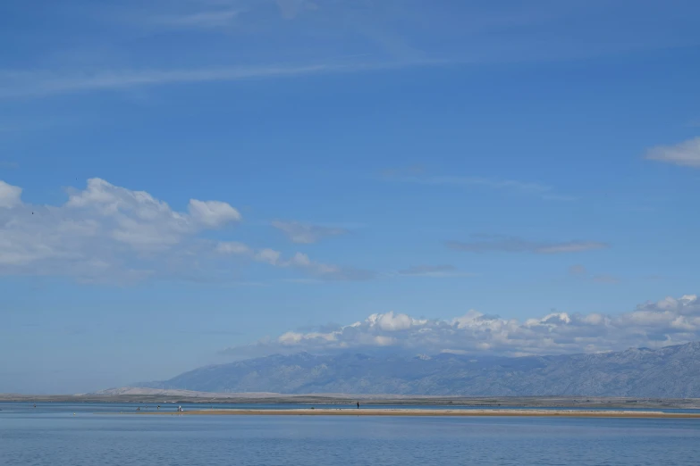 a large body of water that has a kite flying