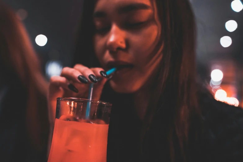 a person sitting down drinking some drinks