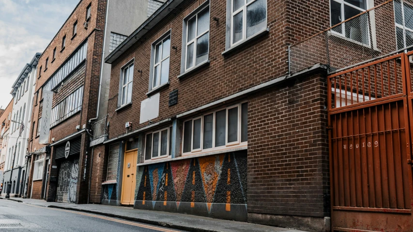 an alley lined with apartment buildings on a street