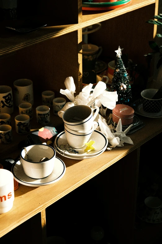 a table topped with white and black dishes and cups