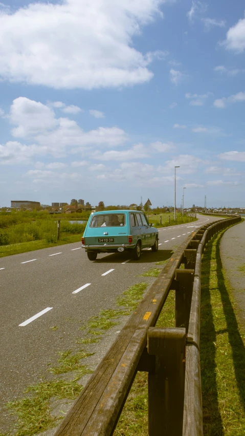 two cars driving along an empty country road