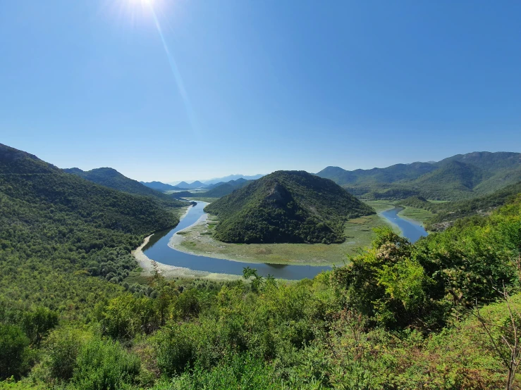 some hills that are near water in the wilderness