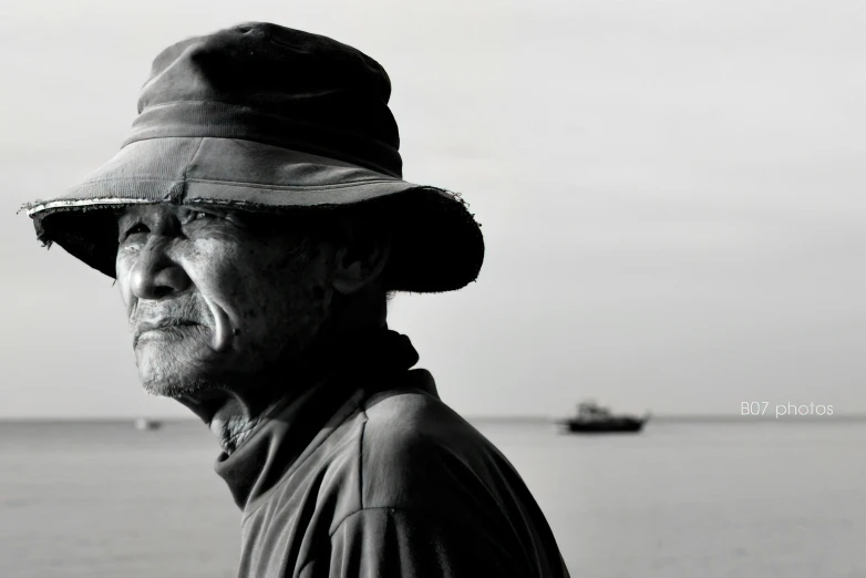 a man wearing a hat looking off into the distance