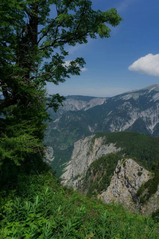 a very pretty mountain range with some clouds in the background