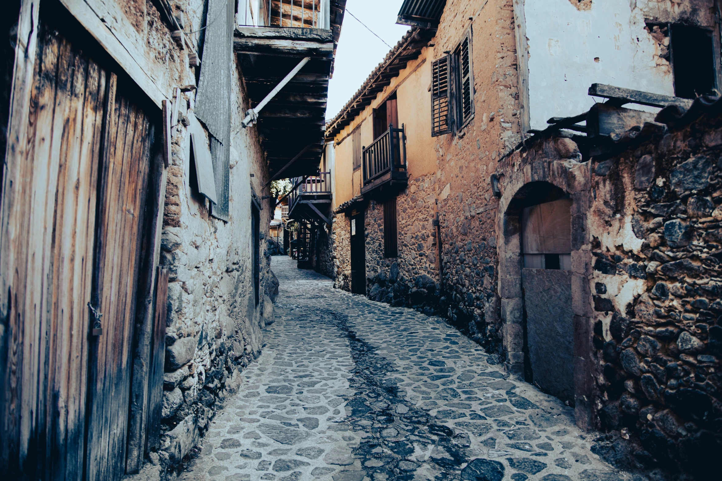 old, weathered buildings line an alley way