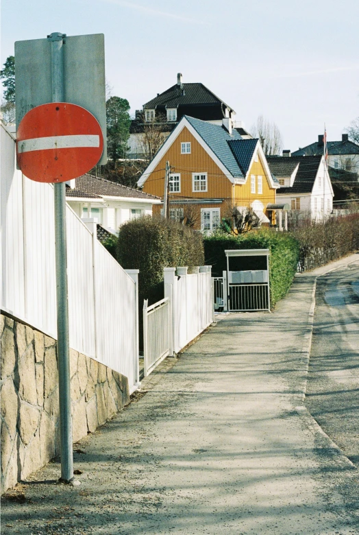 a red and white stop sign sitting next to a wall