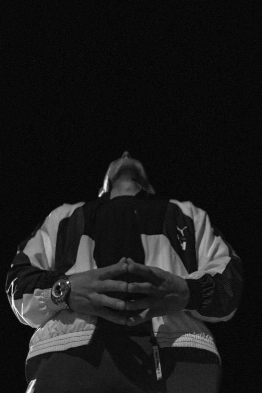 black and white image of a man in the dark taking a po