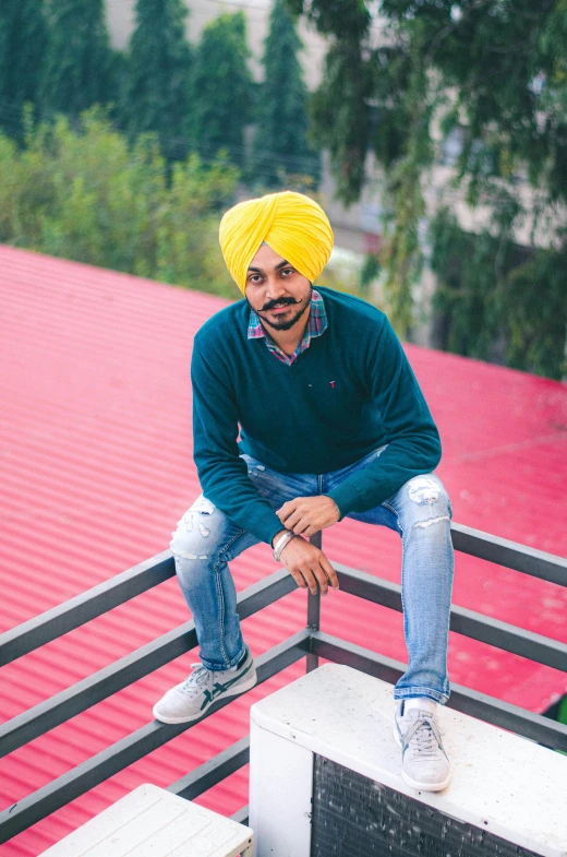 a man sitting on top of a red roof