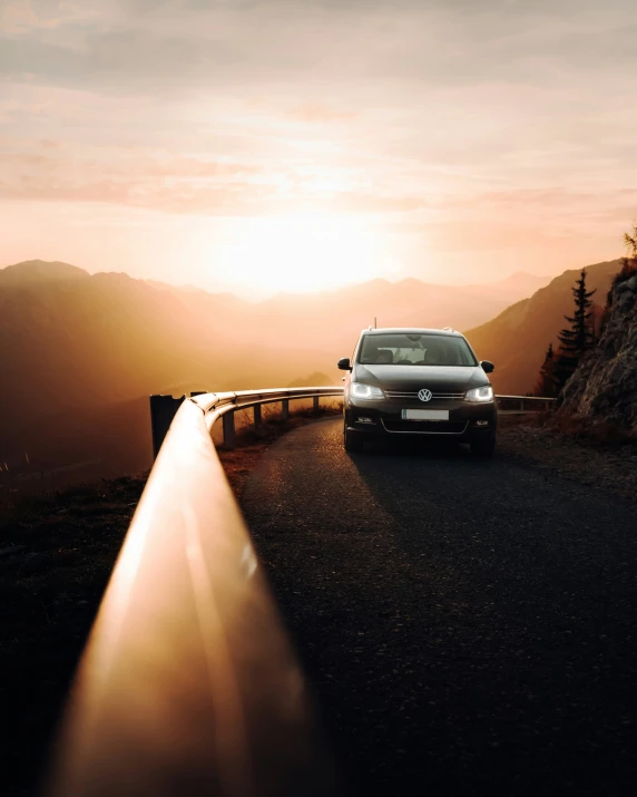 a white car parked near a steep incline of a mountain side