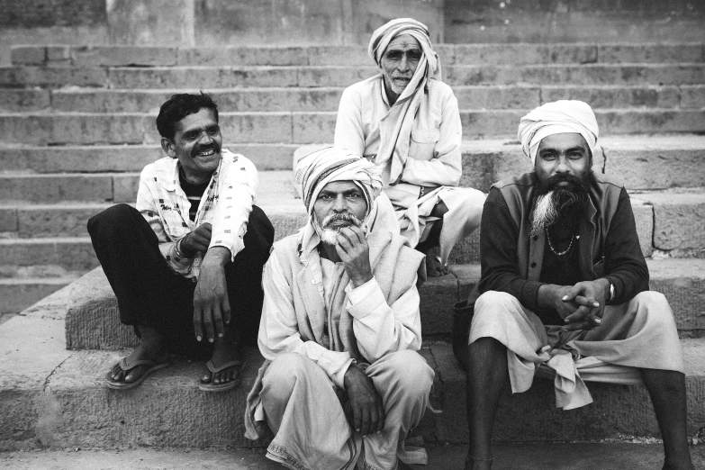 four people are sitting on the steps