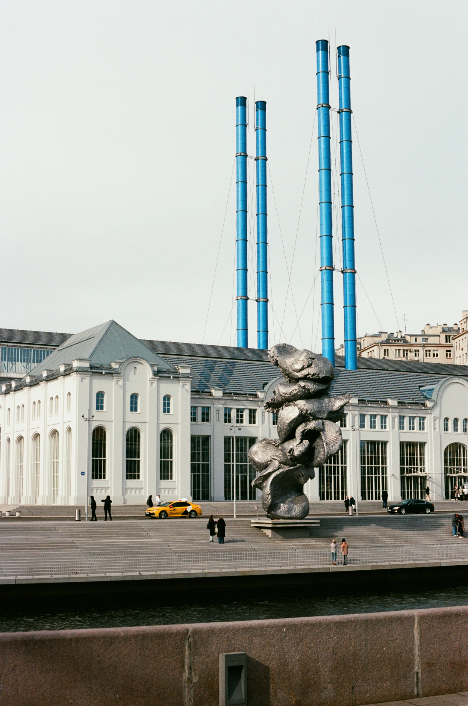 a group of statues on a platform near the building