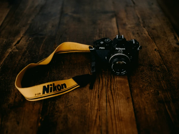 a camera is sitting on a wooden table