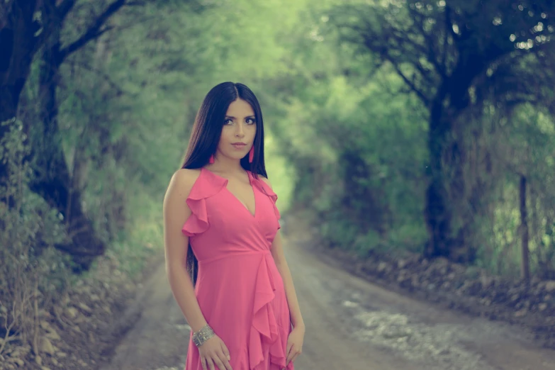 woman standing on a road with her hand in her pocket