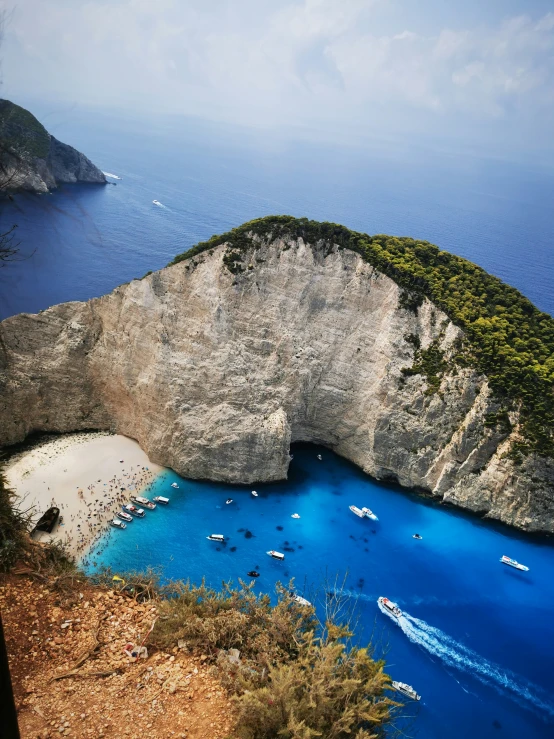 a body of water next to a cliff