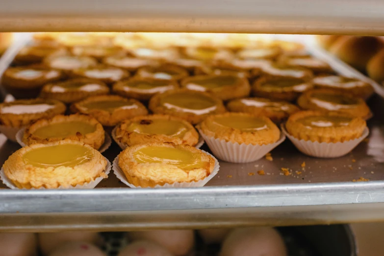 cup cakes are cooling in the oven with one bite out