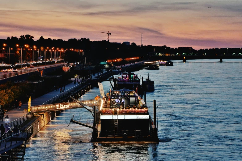 a group of boats on a river near a city