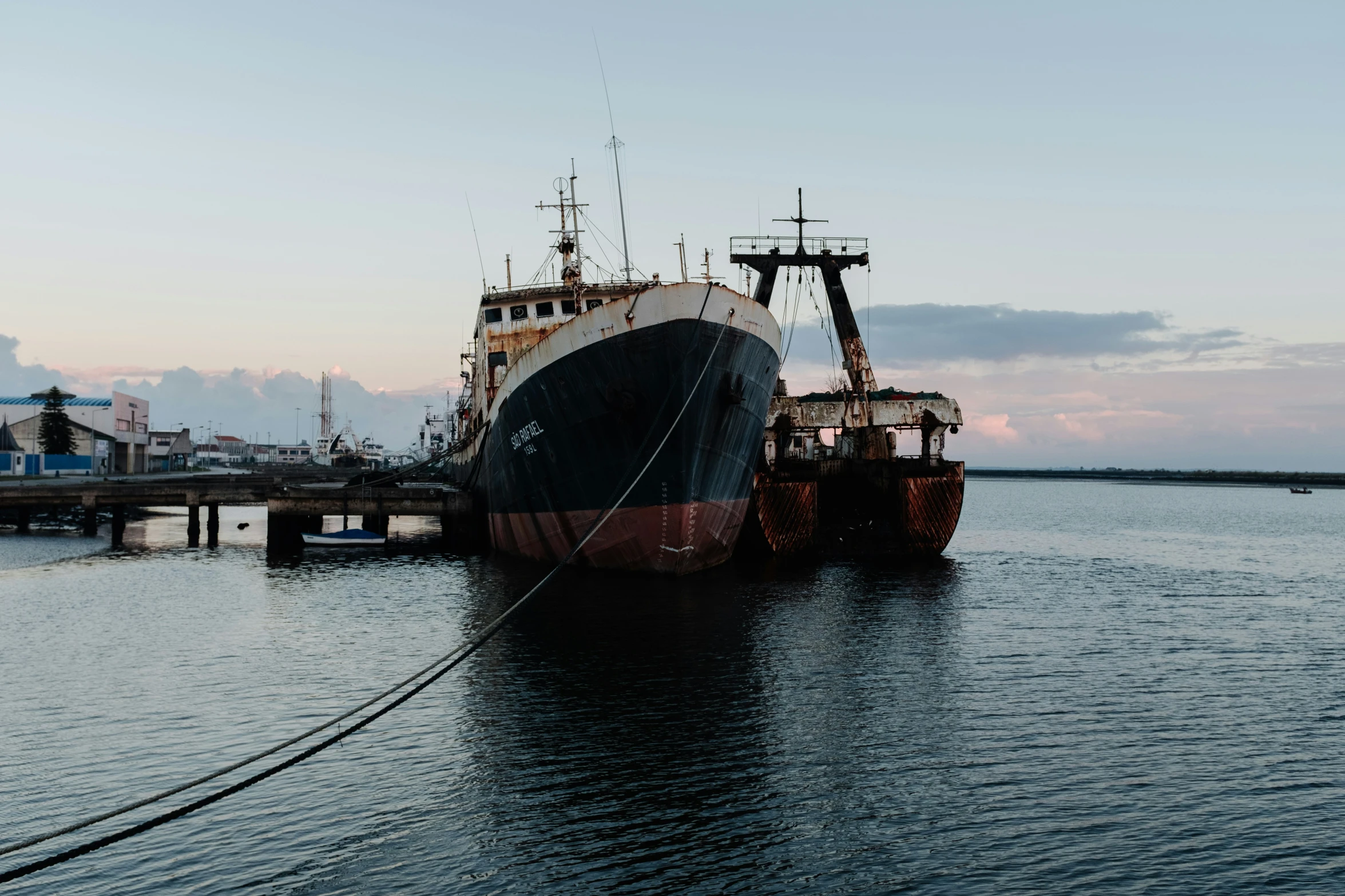 a large boat parked at the end of the pier