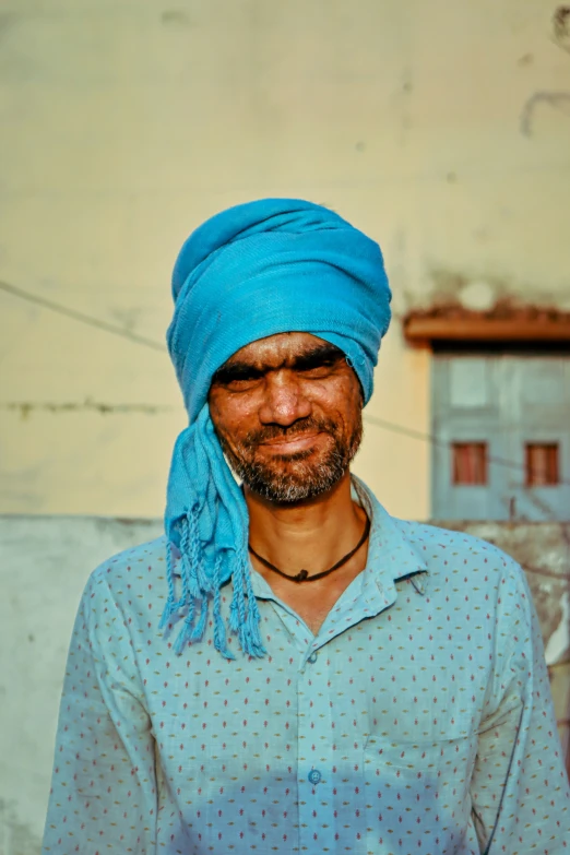 a man in a turban and blue shirt