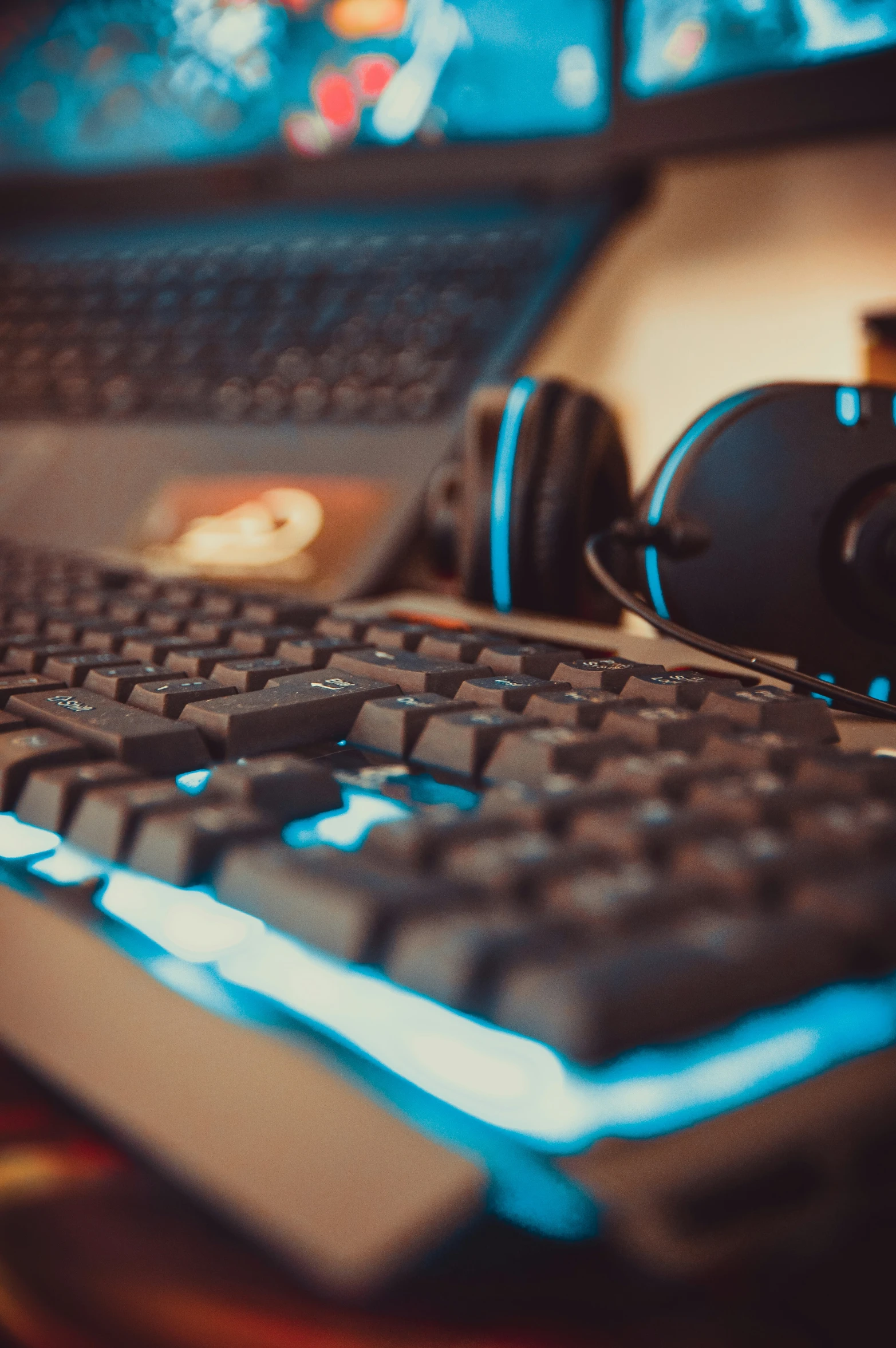 close up of black computer keyboard, mouse, and headphones