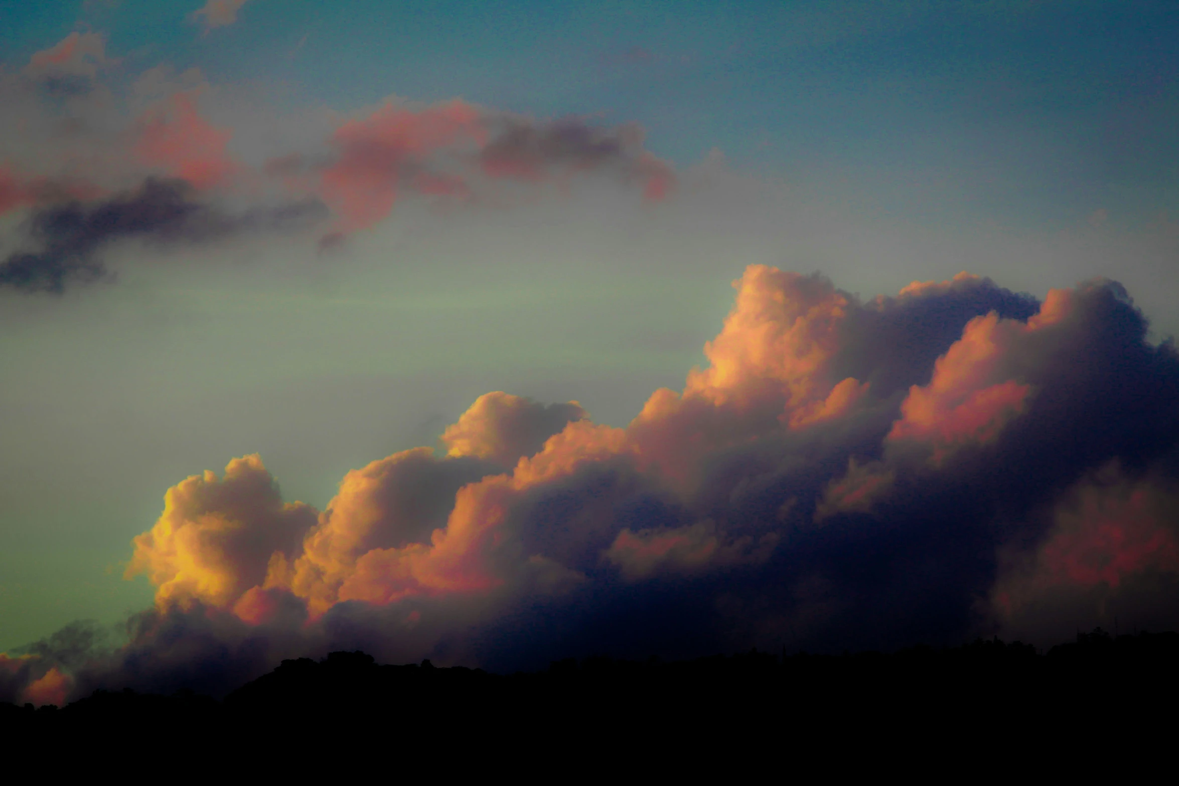 a po of a large amount of clouds at dusk